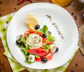 plate of green salad with vegetables, top view,