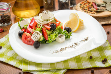 plate of green salad with vegetables, top view,
