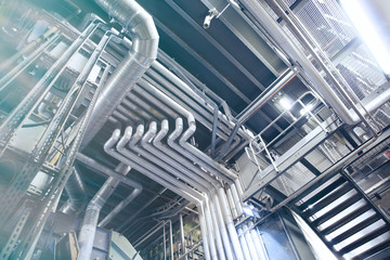 Fototapeta premium Equipment, cables and piping as found inside of a modern industrial power plant