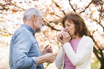 Beautiful senior couple in love outside in spring nature.