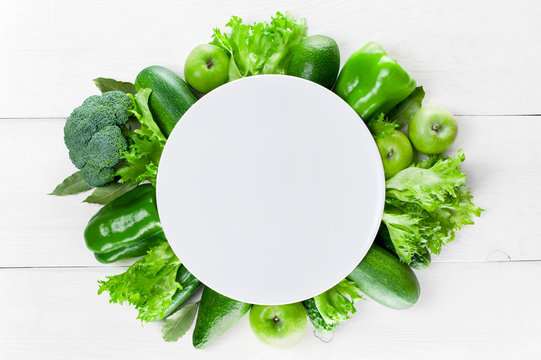 Empty plate with frame of green vegetables