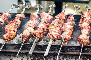 Marinated shashlik preparing on a barbecue grill over charcoal. Roasted stacked meat Shish kebab popular Eastern Europe. Shashlyk (skewered meat) originally made of lamb. Roast Beef Kebabs On BBQ