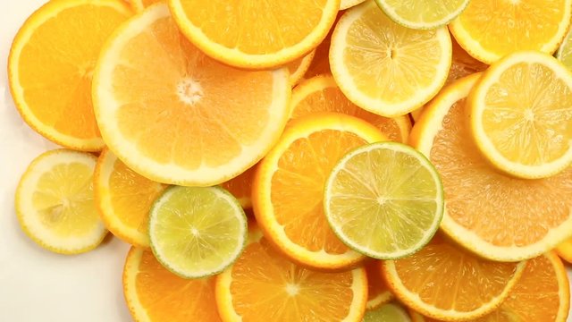 Fresh citrus fruits. Rotation Video footage of the concept of healthy eating and diet. Spinning sliced oranges, lime, lemon, grapefruit