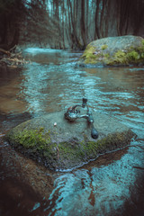 Spinning lies on a rock on a small river