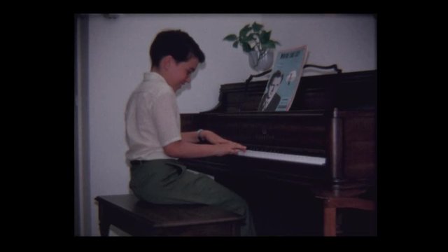 1968 8 year old Proud young boy plays piano and bows