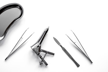 instruments of gynecologist on white background top view