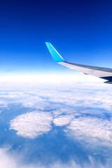Obraz premium Clouds and sky as seen through window of an aircraft