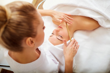 Obraz na płótnie Canvas Massage face woman stone in spa salon.