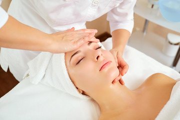 Obraz na płótnie Canvas Beautiful woman at a facial massage at a spa salon.