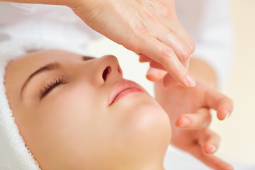 Beautiful woman at a facial massage at a spa salon.