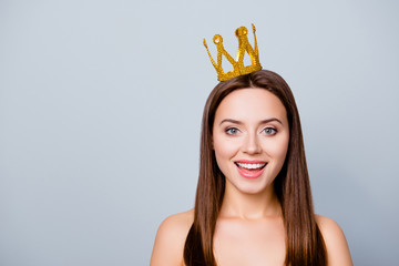 I am number one! Close up photo of cute pretty beautiful young happy woman with a crown on her...