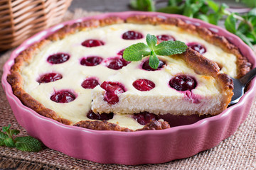 A piece of a pie (cheesecake) with cherry filling