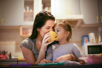 Drinking tea with mom is fun. Little girl.