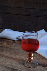 A glass of red wine on rustic wood table. Valentines Day, Birthday, Mother's day, March 8, Wedding still life. Concept greeting card. Copy space for text