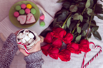 winter breakfast in bed with red roses and heart of sugar candies
