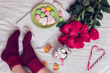 winter breakfast in bed with red roses and heart of sugar candies