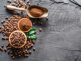 Roasted coffee beans  and ground coffee on wooden table. Top view.