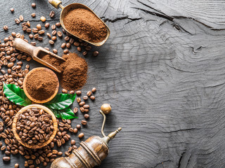 Roasted coffee beans  and ground coffee on wooden table. Top view.