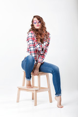 woman in jeans, plaid shirt and sunglasses