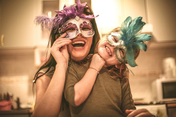 Mom lets hide with mask. Little girl have play with mother.