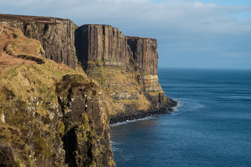 Fototapeta na wymiar Kilt Rock , a sea cliff in north east Trotternish said to resemble a kilt, with vertical basalt columns to form the pleats and intruded sills of dolerite forming the pattern. Isle of Skye, Scotland