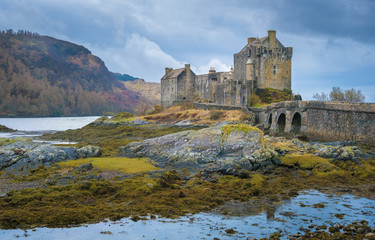 Fototapeta premium Ruins of the Eilean Donan castle, built on a a small tidal island where three sea lochs meet, Loch Duich, Loch Long and Loch Alsh, in the western Highlands of Scotland