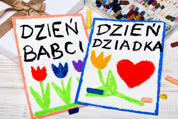 Laurki z Okazji Dnia Dziadka i Dnia babci. Kolorowy rysunek, kredki i prezent ze złotą kokardą. 