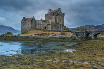 Fototapeta premium Ruins of the Eilean Donan castle, built on a a small tidal island where three sea lochs meet, Loch Duich, Loch Long and Loch Alsh, in the western Highlands of Scotland