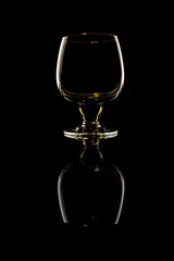 Glass of cognac on black