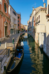 Obraz na płótnie Canvas Venice, Italy - August 14, 2017: Venice canal with boats and classic buildings.