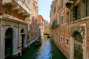 Venice, Italy - August 14, 2017: Venice canal with boats and classic buildings.