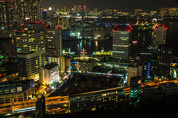 Aerial view over Tokyo cityscape, the Bay area with its bridges and Odaiba by night from Tokyo World Trade Center, Tokyo, Japan. Closeup of Tokyo cityscape.