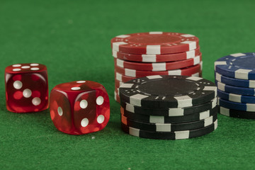 two red dices and different color chips