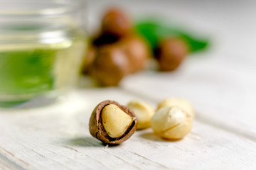 Nice macadamia nuts on the white wooden table.