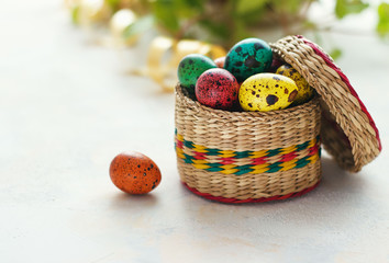 Easter background with Easter eggs in the basket and spring flowers