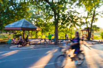 People ride a bike in public park