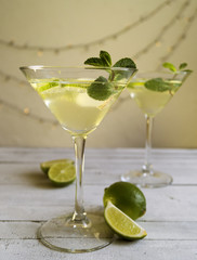 Drink in Martini glass on a gray background.