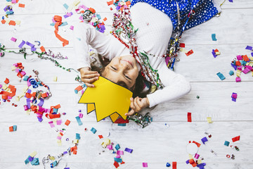 Little girl child cute and beautiful with multi-colored confetti on the floor happy is happy in a...