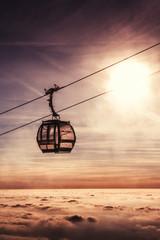 cable car in winter mountain, inverse scenery in sunrise