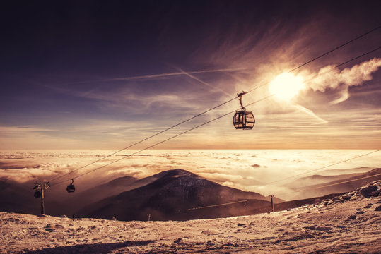cable car in winter mountain, inverse scenery in sunrise