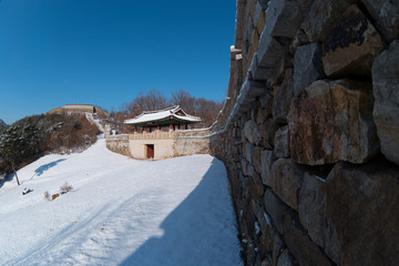 Fototapeta na wymiar Korean Gomo Mountain Fortress Wall Palace covered with Snow in Winter
