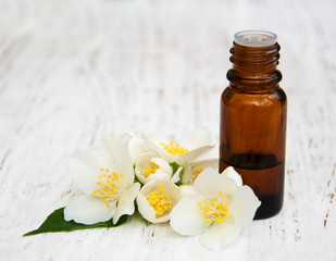 Fototapeta na wymiar Massage oil with jasmine flowers