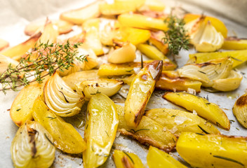 Home made baked potatoes with onion, herbs, pepper and sea salt