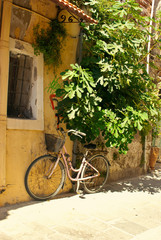 Old bicycle against the wall on the street