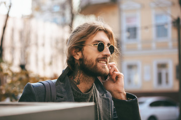 Fototapeta premium Portrait of a smiling bearded man in sunglasses