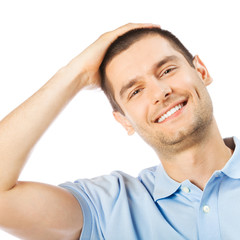 Obraz premium Cheerful thinking young man, over white