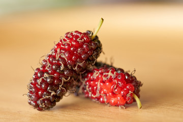 close up mulberry on wooden table background. The fruit of the Black Mulberry, native to southwest...