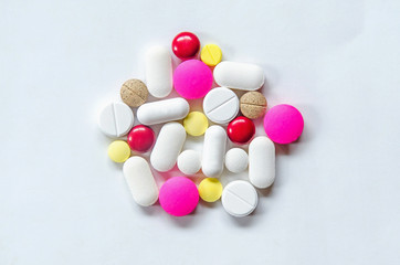 Top view of the pills on the white background, The drug and capsule pills on the floor, Pile of the drug and pills on the white background.