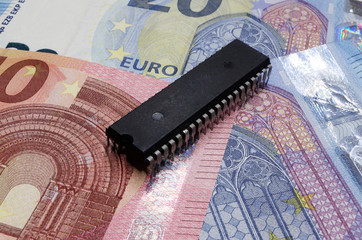 Microchip lying on euro banknotes
