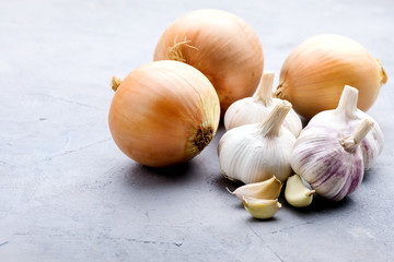 Organic Beautiful Onions and Garlic Bulbs on Background Copy Space